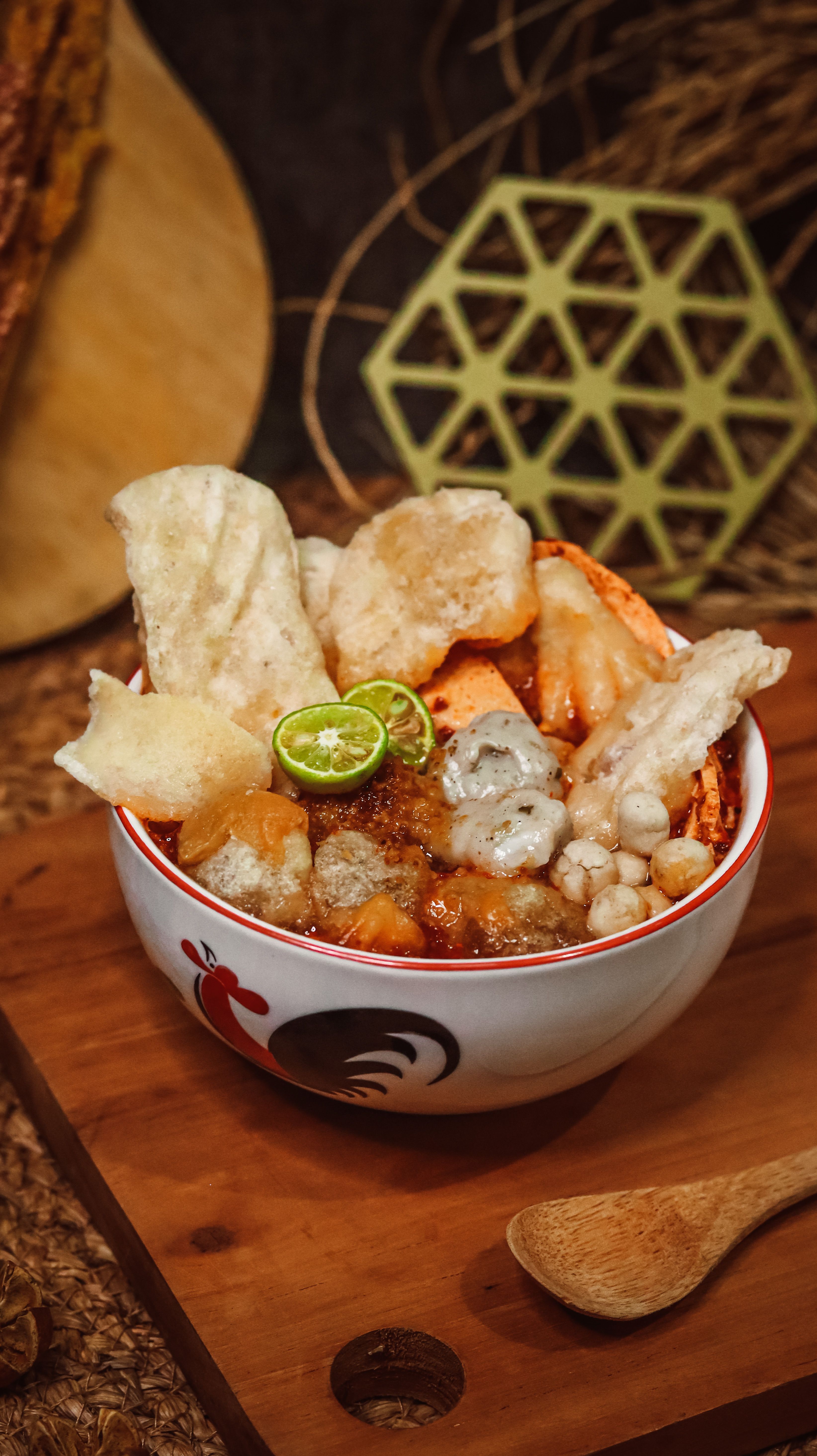 Mouthwatering bowl of Indonesian Empal Gentong with lime and crackers, perfect for food lovers.