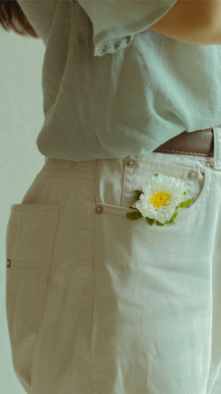 Close-up Of Flower In Woman Pants Pocket