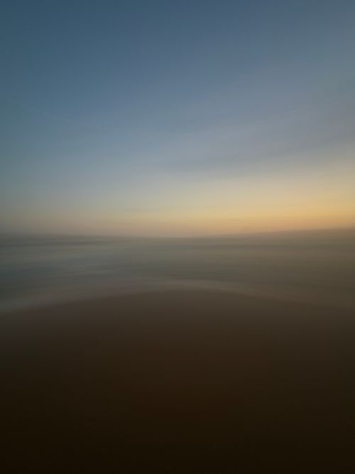 Free Capture the serene beauty of the ocean during sunset with a calm, dramatic sky. Stock Photo