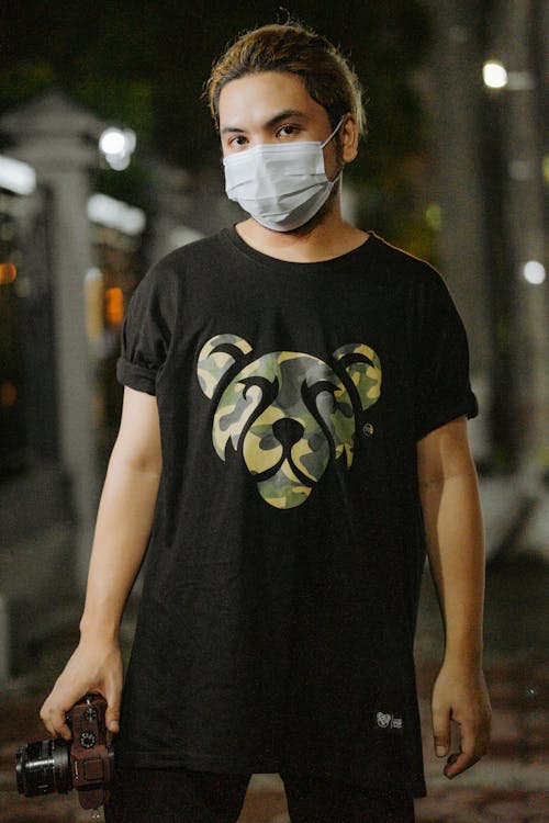 A Man in Black Crew Neck T-shirt Wearing White Mask