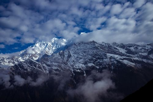 Free Stunning view of the snow-capped Himalayas breaking through clouds in Nepal's winter landscape. Stock Photo
