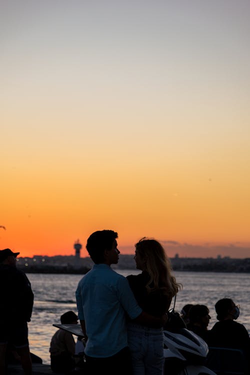 Silhouette of a Couple Hugging during Sunset