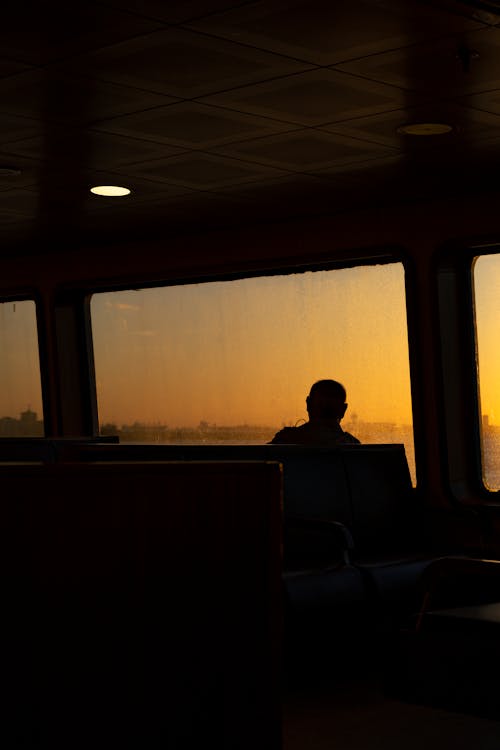 Silhouette of Man in Public Transport on Sunset