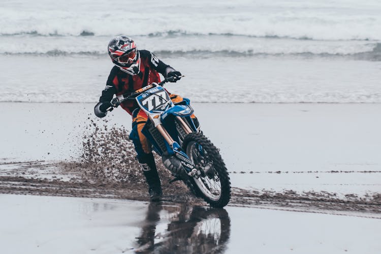 Man Riding On Bike On Beach