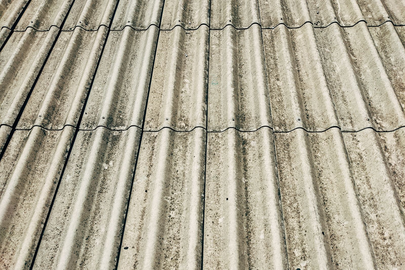 Edge of a slate roof with newly fitted aluminium seamless gutter