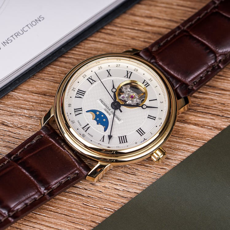 Frederique Constant Brown Leather Strap On Wooden Surface