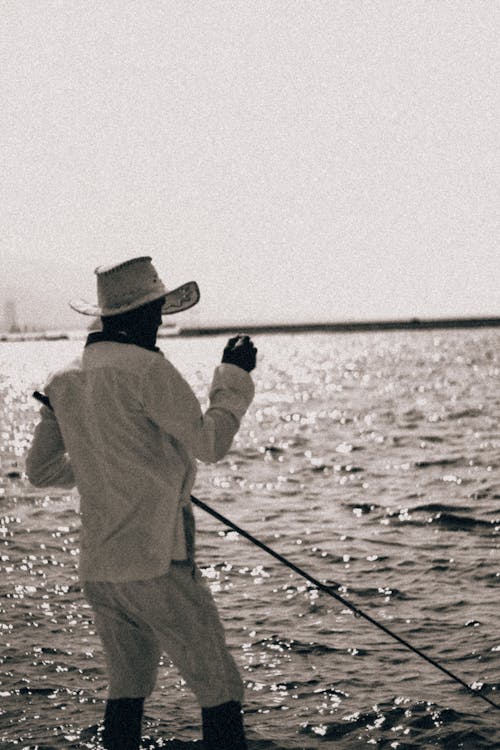 Back View Shot of a Person Holding a Fishing Rod