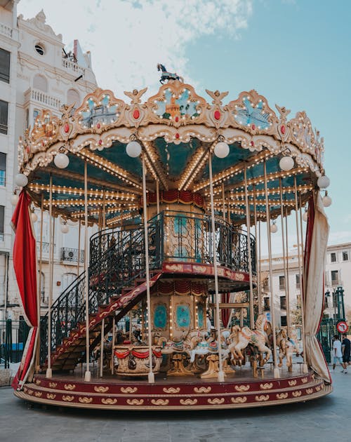 A Carousel on the Street Near White Building