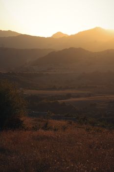 Tranquil mountain landscape showcasing warm golden hour sunset colors.