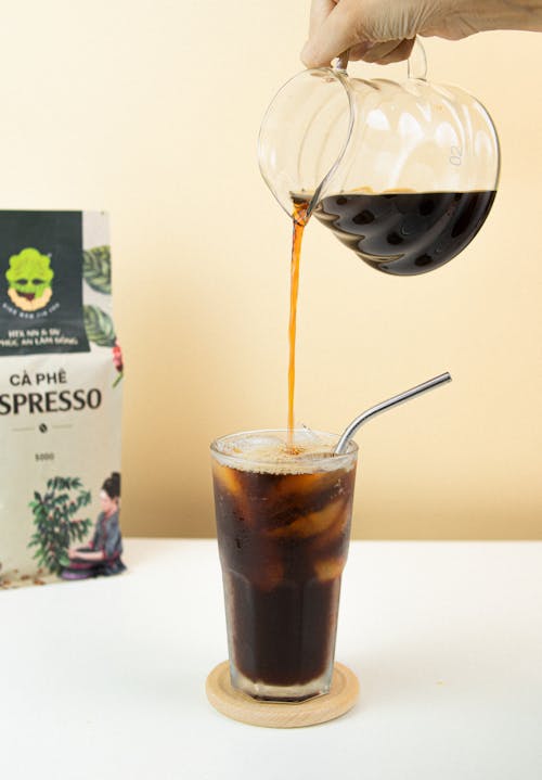 A Person Pouring Coffee in the Glass