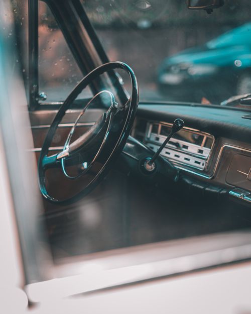 Free Close-up view of a vintage car's classic interior highlighting the steering wheel and dashboard details. Stock Photo