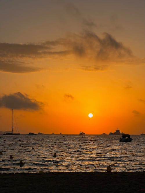 Silhouette of Boats on Sea During Sunrise