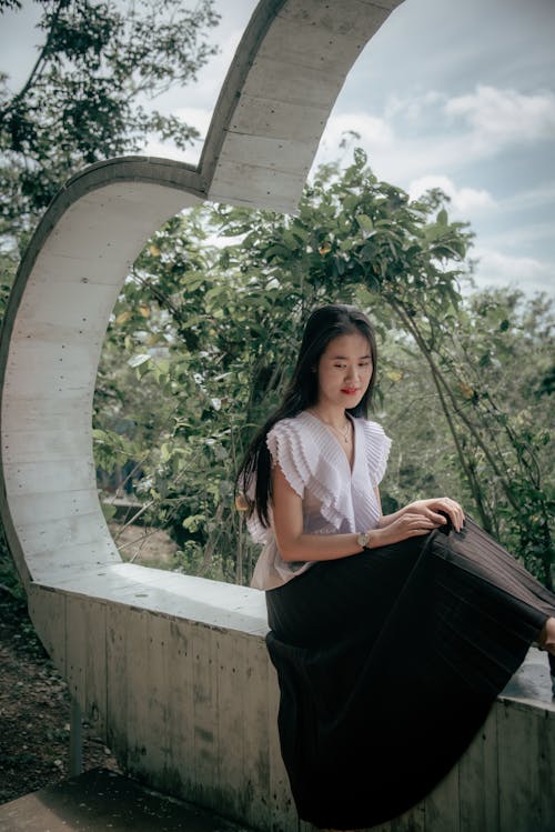 Woman  Wearing a White Top and Black Skirt