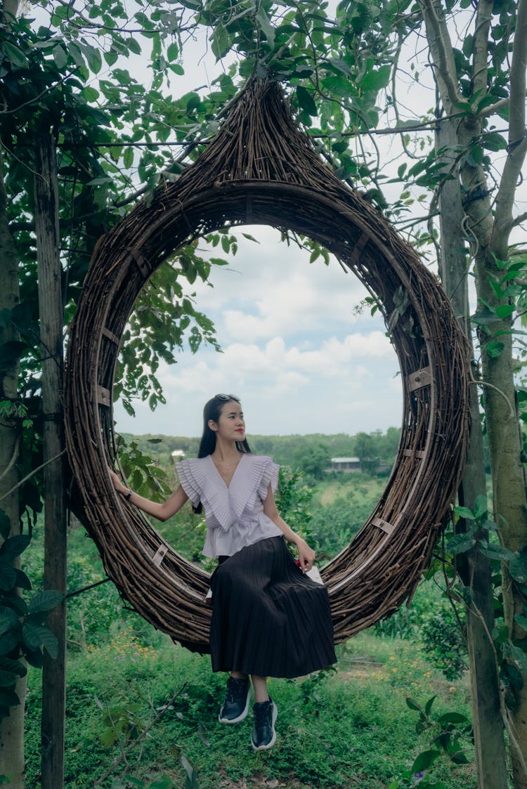 Beautiful And Cute Asian Girl Siting On A Nest In The Forest