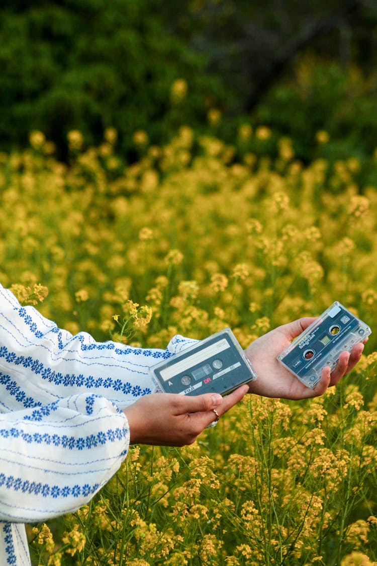 A Person Holding Cassette Tapes