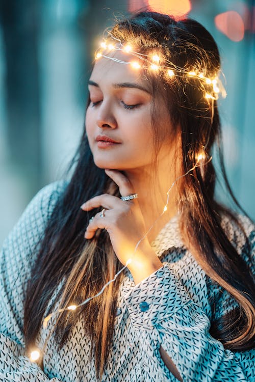 Close Up Photo of Woman with String Lights on Her Head