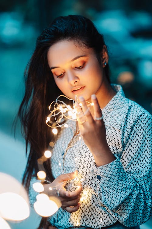 Photo of Woman Holding String Lights