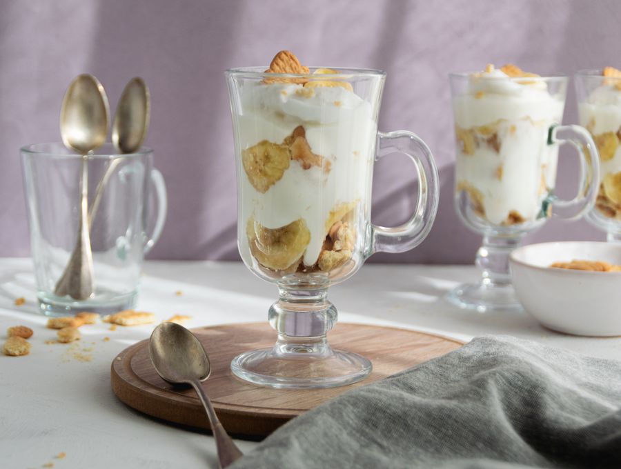 Banana pudding with creamy layers served in a clear glass cup
