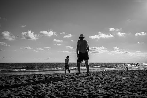 Grayscale Photography of People on the Beach