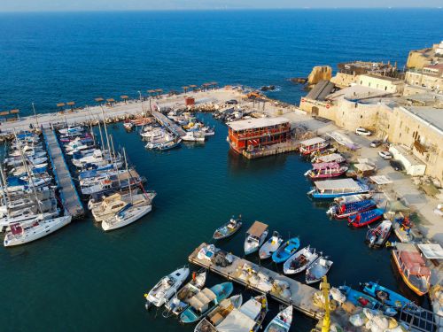 Free Stunning aerial view of Acre marina showcasing docked boats and historic buildings in Israel. Stock Photo