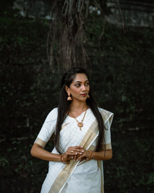 Woman in White and Brown Saree Wearing Jewelry