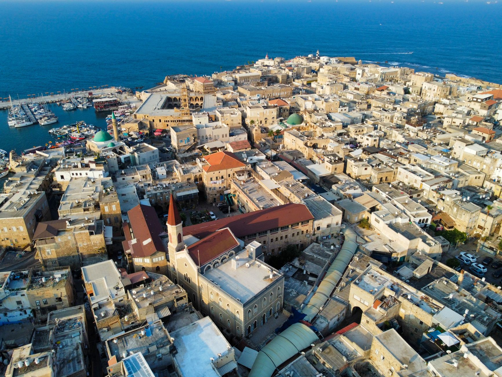 Drone view capturing the historic architecture of Acre, Israel with the sea backdrop.