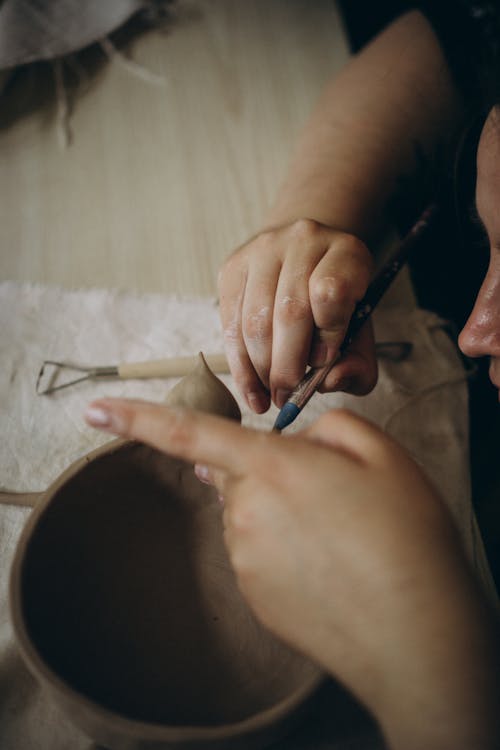 Woman Painting a Pottery Article