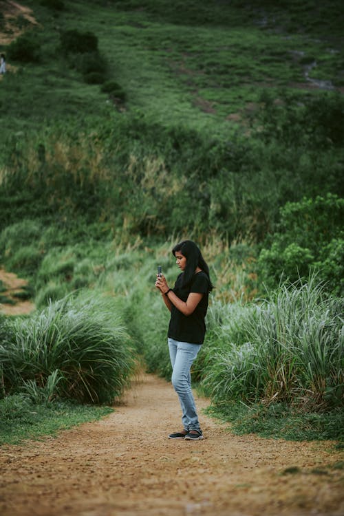 woman-taking-picture-in-countryside