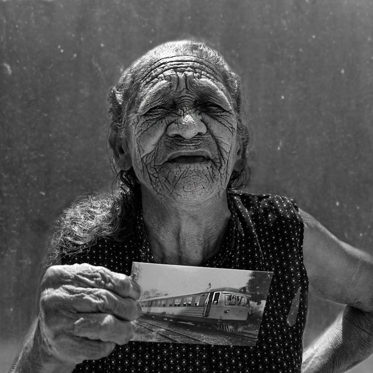 Elderly Woman Holding An Old Photo