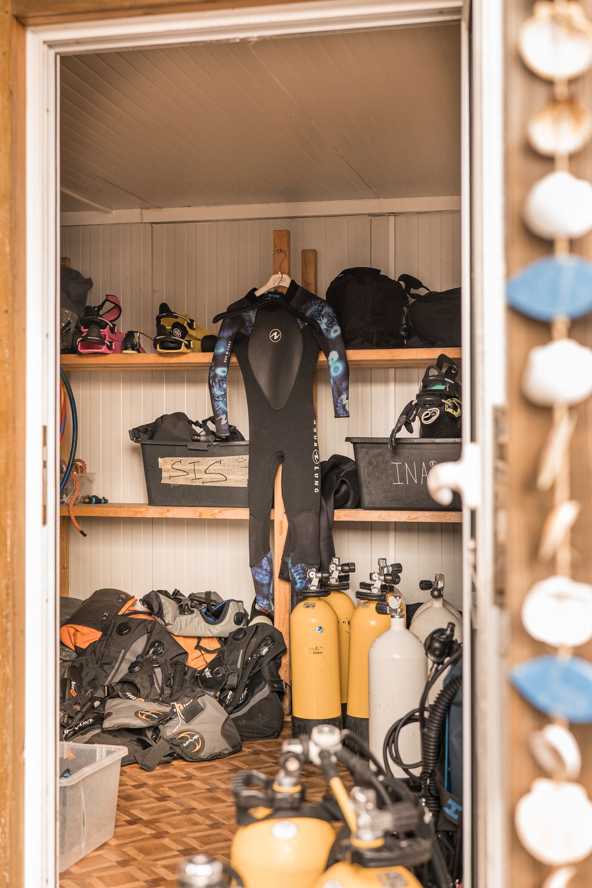 Neatly organized scuba diving equipment in storage