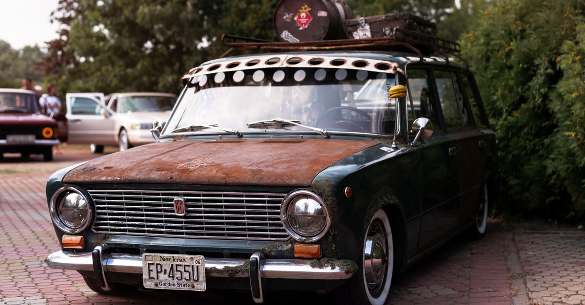 Rusty Hood Vintage Car with Rusty Hood Parked on Stone Pavement · Free Stock Photo