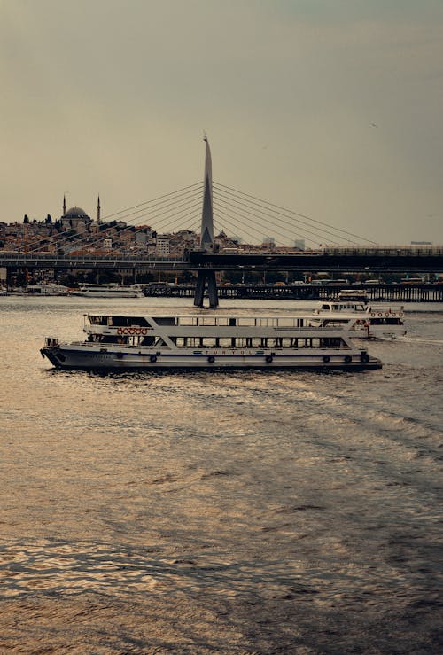 White Ferryboat on Body of Water Near the Bridge