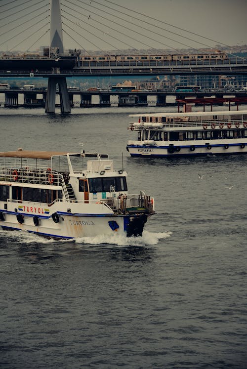 Free Ferry Boats on Body of Water Near Bridge Stock Photo