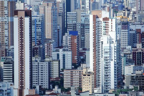 Free Aerial view of modern high-rise buildings in São Vicente, capturing the dense urban landscape. Stock Photo