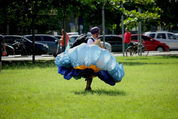 Man With Parachute On Grass