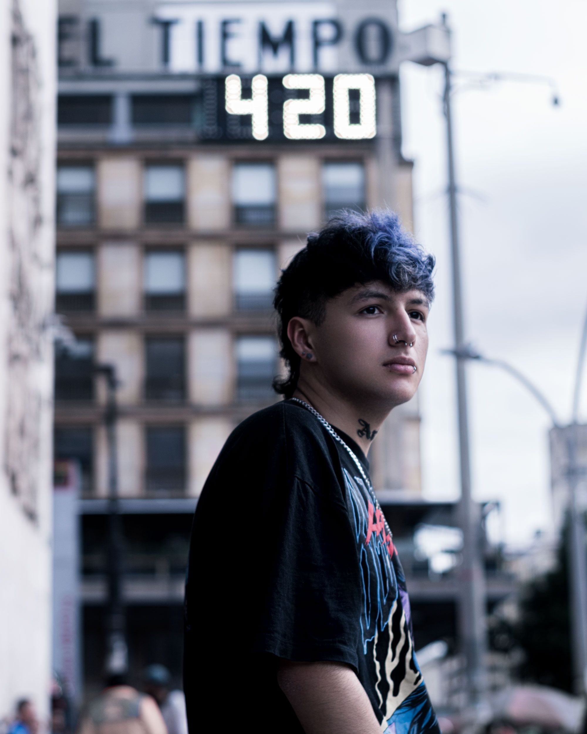 Street portrait of a young man with blue hair in Bogotá, Colombia.