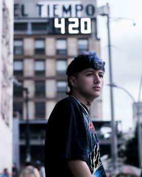 Street portrait of a young man with blue hair in Bogotá, Colombia.