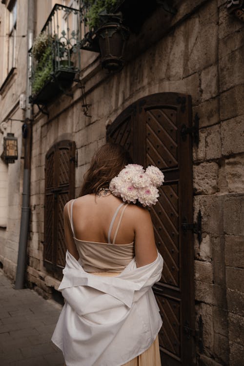 Back View of a  Woman Holding Flowers