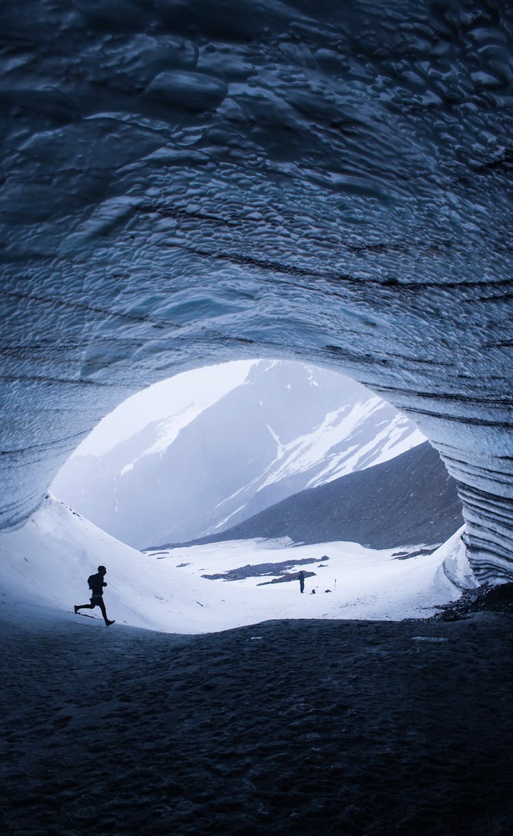 People Exploring A Glacier And A Cave 