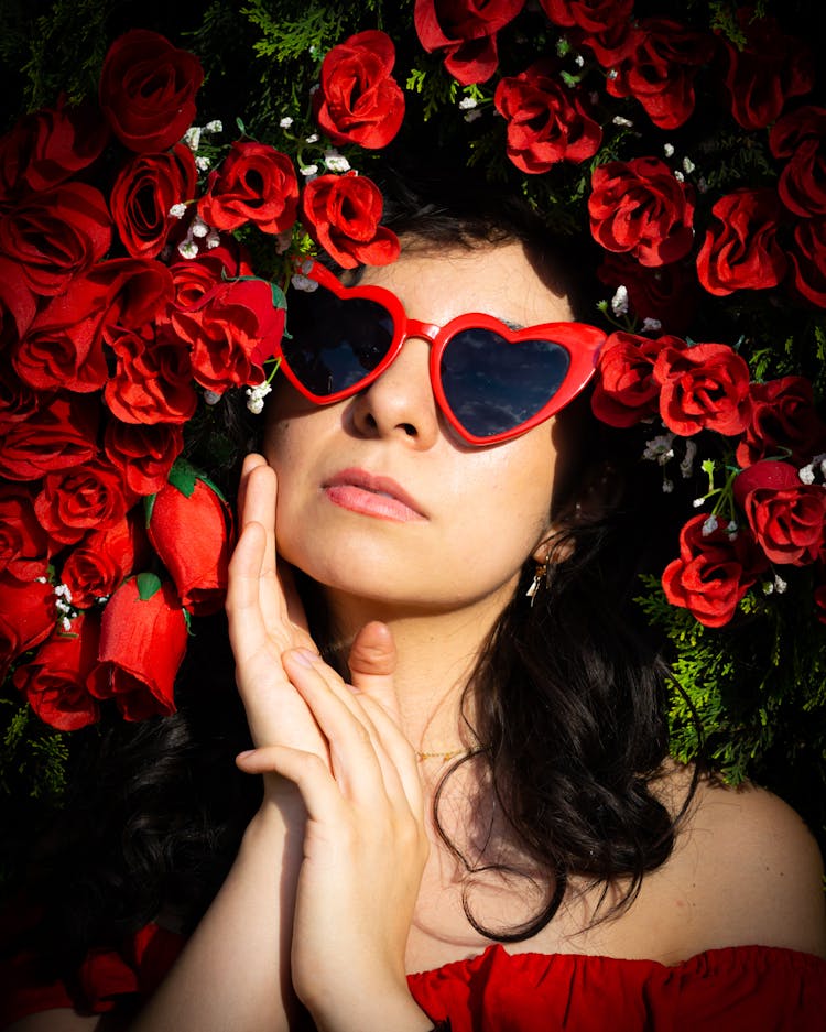 Woman Wearing A Glamorous Heart Shaped Sunglasses Surrounded With Red Roses