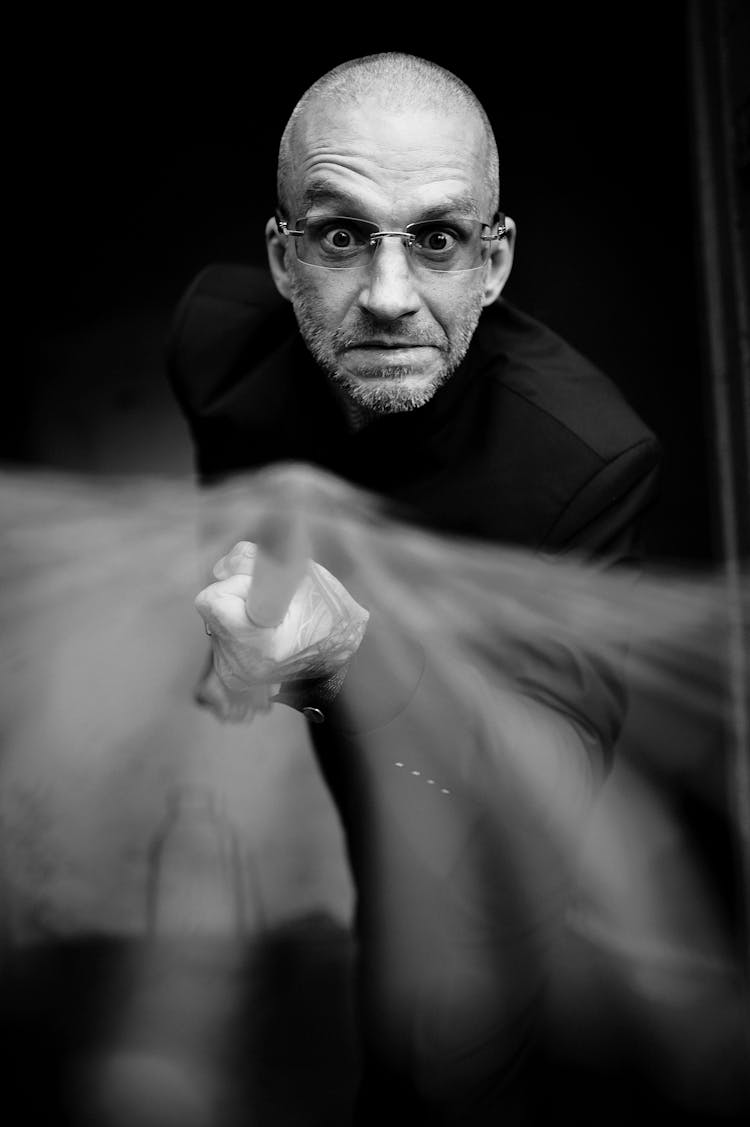 Grayscale Photo Of A Man Holding A Rake