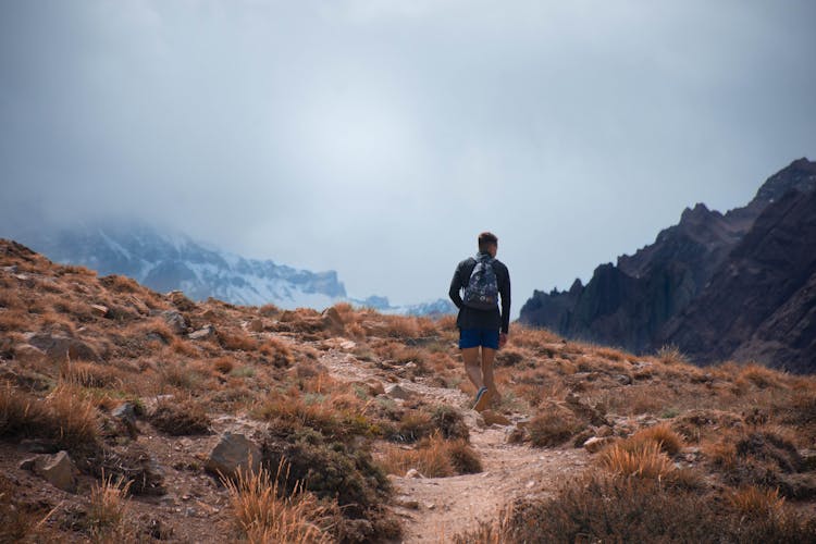 A Man Hiking On The Mountain