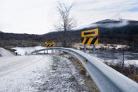 Snow-covered road with safety signage in Ushuaia, Tierra del Fuego, Argentina during winter.