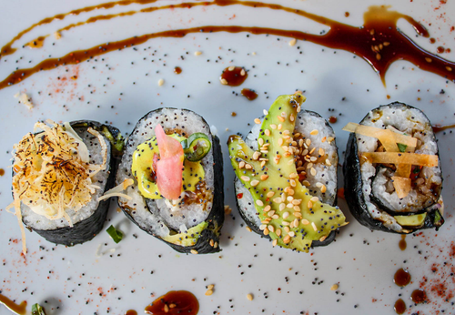 Free Delicious gourmet sushi rolls with diverse toppings on a ceramic plate, Medellín. Stock Photo