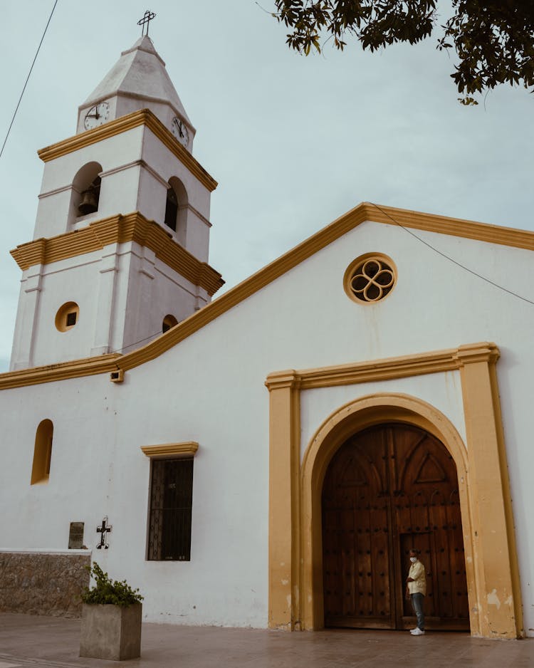 Man Standing On Doorway Of A Church Building