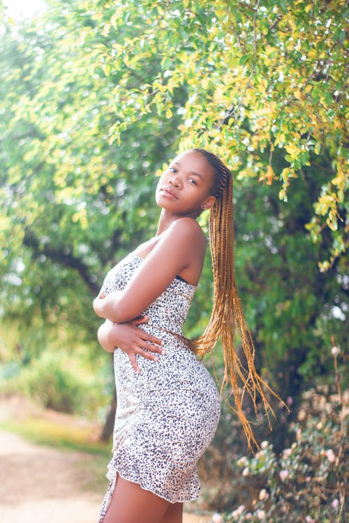 Woman in White and Black Floral Dress Posing