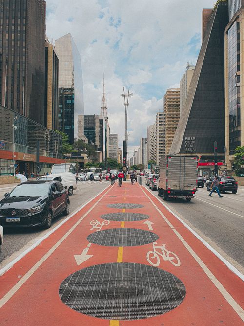 Free Dynamic urban scene of Avenida Paulista with bicycle path and skyscrapers in São Paulo, Brazil. Stock Photo