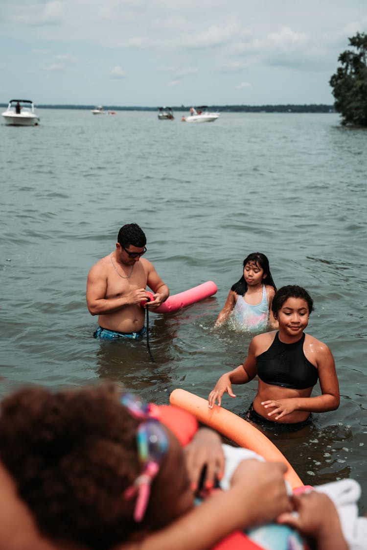 People Swimming On The Lake