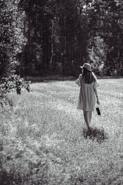 Woman Walking on a Field in Summer 