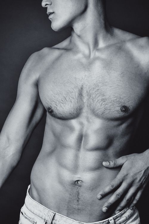 Free Monochrome photo of a fit, topless man showing muscular definition. Stock Photo